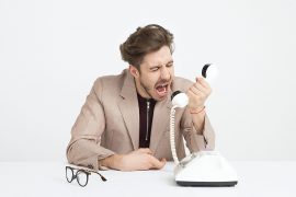 Angry male yelling on phone. Minimize anger with a therapist for anger issues near Greewood Village, CO. Learn more about how anger management therapy in greenwood village, co can help you